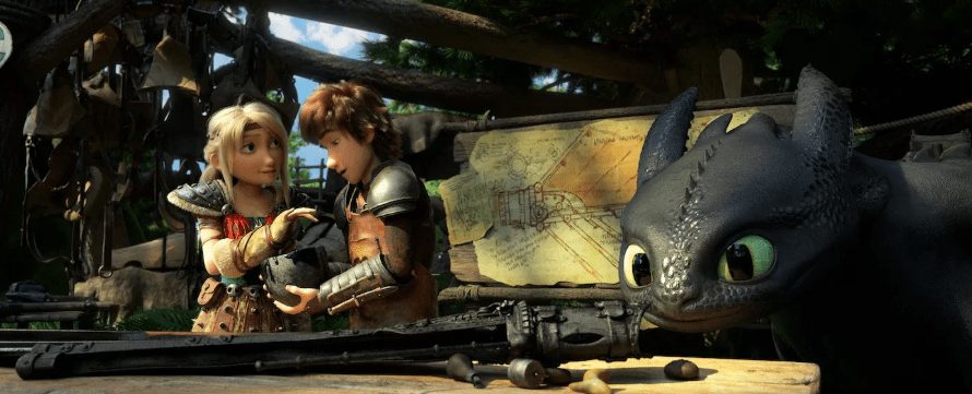 Hiccup and Astrid working on the design for Toothless’s prosthetic tail fin at a wooden workbench while Toothless looks on.